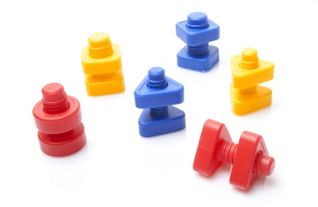 Colourful toy nuts and bolts on white backgroundの写真素材