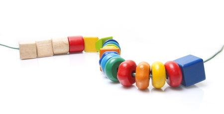 Colorful wooden beads toy on white backgroundの写真素材