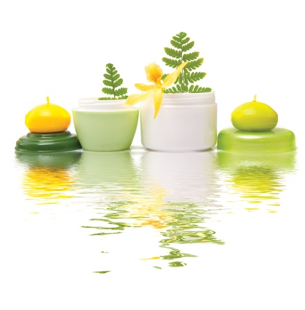 Composition of cosmetic products with flower on white background Composition of cosmetic products with flower on white background