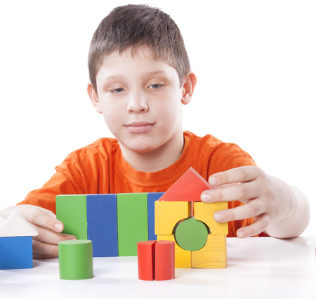 boy playing toy blocks isolated on white backgroundの写真素材