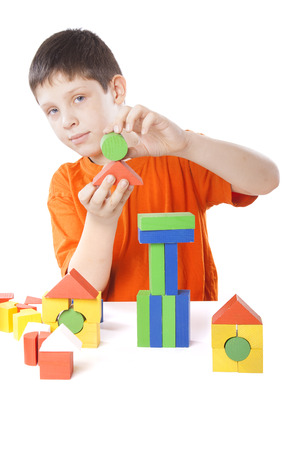 boy playing toy blocks isolated on white backgroundの写真素材