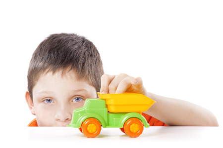 boy playing with toy car isolated on white backgroundの写真素材
