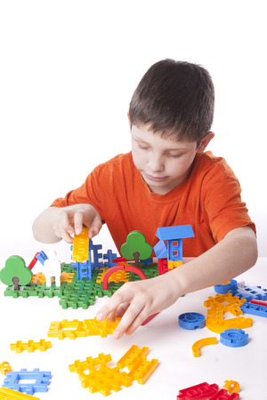 boy playing with color toy isolated on white backgroundの写真素材