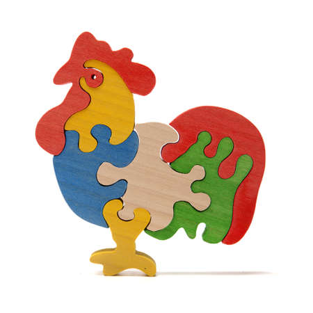 Wooden cock puzzle on the whiteの写真素材