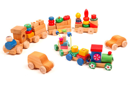 Wooden trains and cars puzzle with coaches on the whiteの写真素材