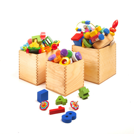 Three wooden boxes with very many toysの写真素材