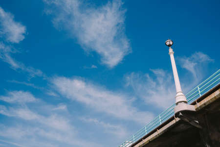 Lamp post on pier with skyの写真素材