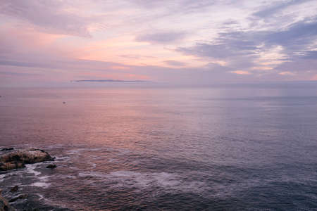 Ocean at sunset with clouds