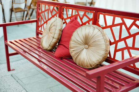 A bench with asian design and festive pillowsの写真素材