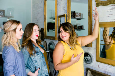 A young business owner speaks to her employeesの写真素材