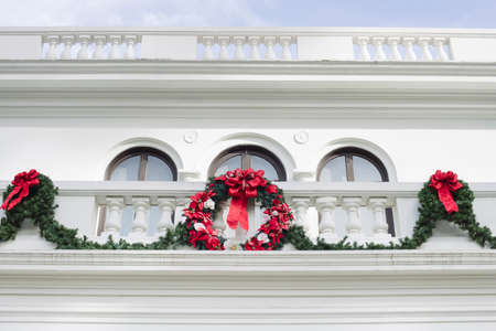 White Mansion home with Christmas decorations wreath and garlandの写真素材