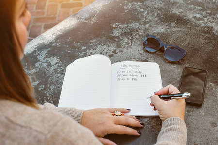 Profile of a female millennial writting down her life goalsの写真素材