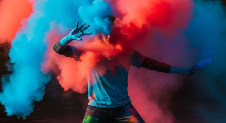 Young man in colored smoke. The guy in the image of a teenager.の素材