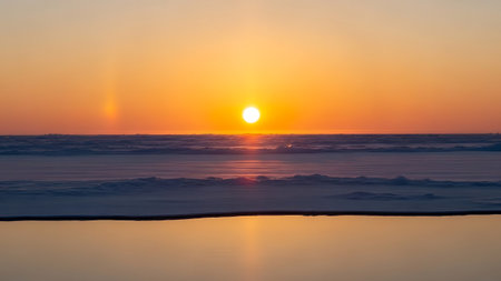 Sunset over the sea with reflection on the water. Beautiful natural background.の素材