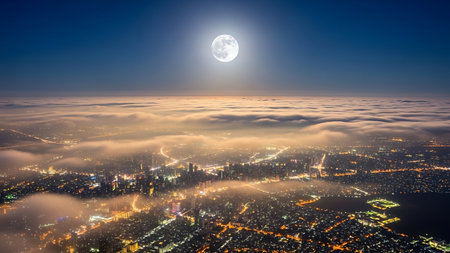 Aerial view of a city in the fog at night with full moonの素材