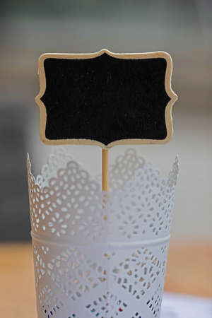 Homemade plywood place card on stick in storm lanternの写真素材