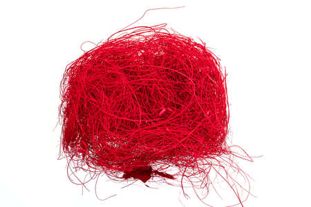A ball of red colored flax hair ribbon isolated on white background