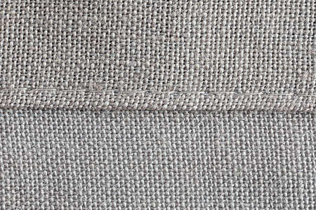 extreme close up of a hem of woven cotton fabric