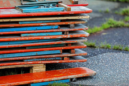 tidy and stacked wooden tables in a garden. in Bavaria customary outdoor furniture for happy get-togethers with many friendsの写真素材