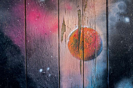 maybe a sprayed sunrise, sunddown or galaxy on a old wooden wall