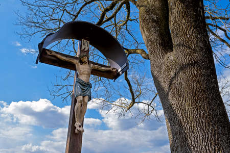 frequent sight in Bavaria, Jesus on the cross, carved sculpture on the waysideの写真素材