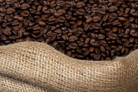 close up of roasted coffee beans in a jute sackの写真素材