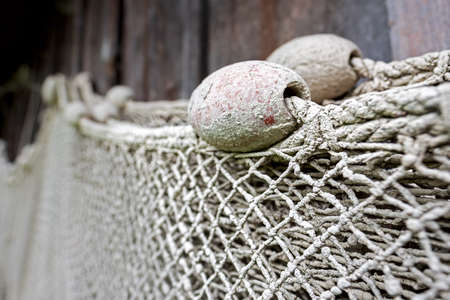 Close up of a fishing net covered with dried mudの写真素材