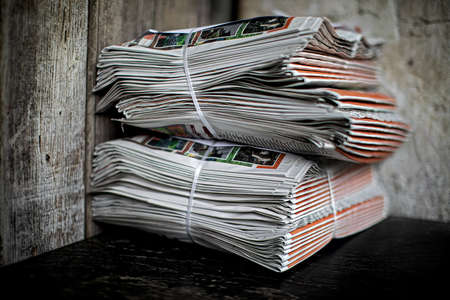 two bundles of newspapers waiting to be picked up