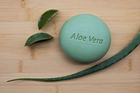 aloe vera soap with fresh aloe vera leaf on bamboo backgroundの写真素材