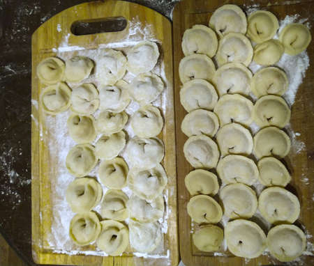 dumplings, handmade lie on a wooden boardの写真素材