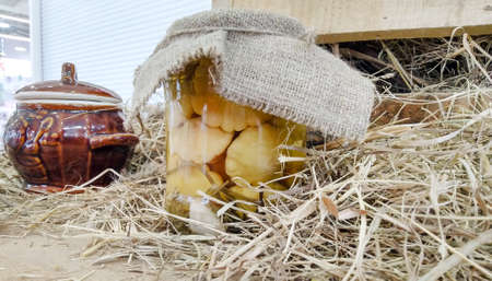 in a straw there is a can with canned vegetables, handmadeの写真素材