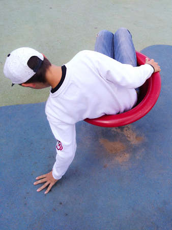 the boy spins on a chair in a break dance.
