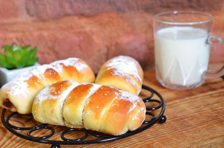 homemade yeast rolls lie on a metal rack and a vintage board