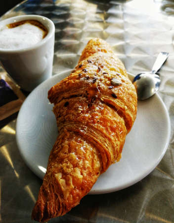 Morning breakfast with croissant and coffee