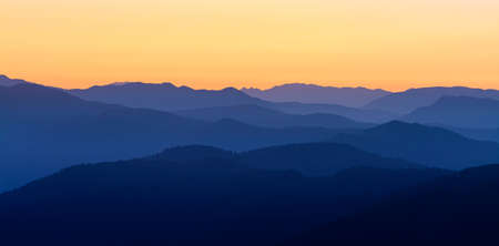 Mountain Silhouette toward alps and dolomites from the Mount Pizzoc (Veneto, Italy) top at sunset in...