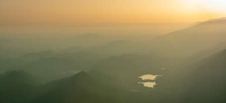 Sunset on the top of Mount Pizzoc, landscape of the Po Valley toward the Revine lakes and the...