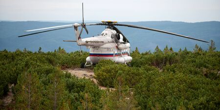 Russia - August 27, 2013: Helicopter MI-8 landed on the mountian.