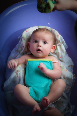 A baby bathing in the bathtub at home.の写真素材