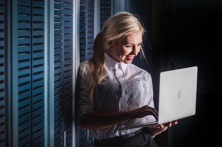 Young engineer businesswoman in network server room. Russia.の写真素材