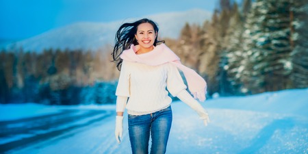 Snow winter woman portrait outdoors on snowy white winter day.