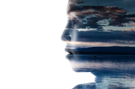 Double exposure portrait of a woman combined with photograph of nature