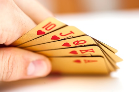 Golden playing poker cards on white background