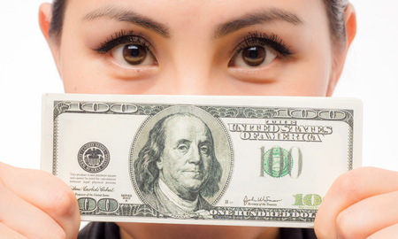 Young asian businesswoman with money on white background