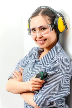 Young woman with a drill at home.の写真素材