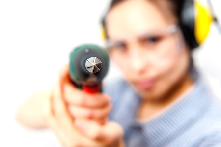 Young woman with a drill at home.の写真素材