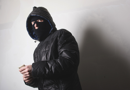 Robber with a gun in a maskの写真素材