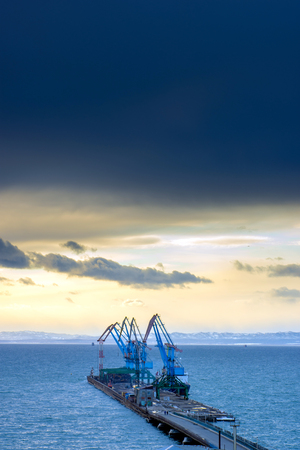 a row of crane at the seaport in Sakhalin islandの写真素材