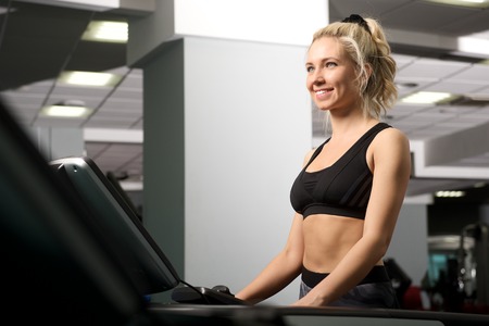Young beautiful woman works out in the gym