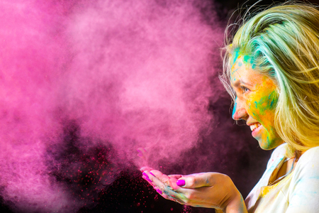 Portrait of a beautiful female with holi paintの写真素材