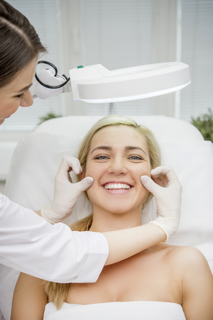 Happy female patient at a clinic visiting the doctorの写真素材